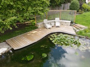 semi floating deck with kent ragstone walling, reclaimed yorkstone copings and trellis work
