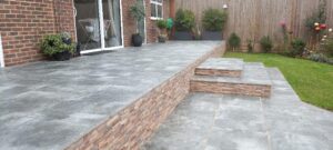 2 level patio laid in Burlington blue porcelain, walls cladded with St Moritz desert porcelain.